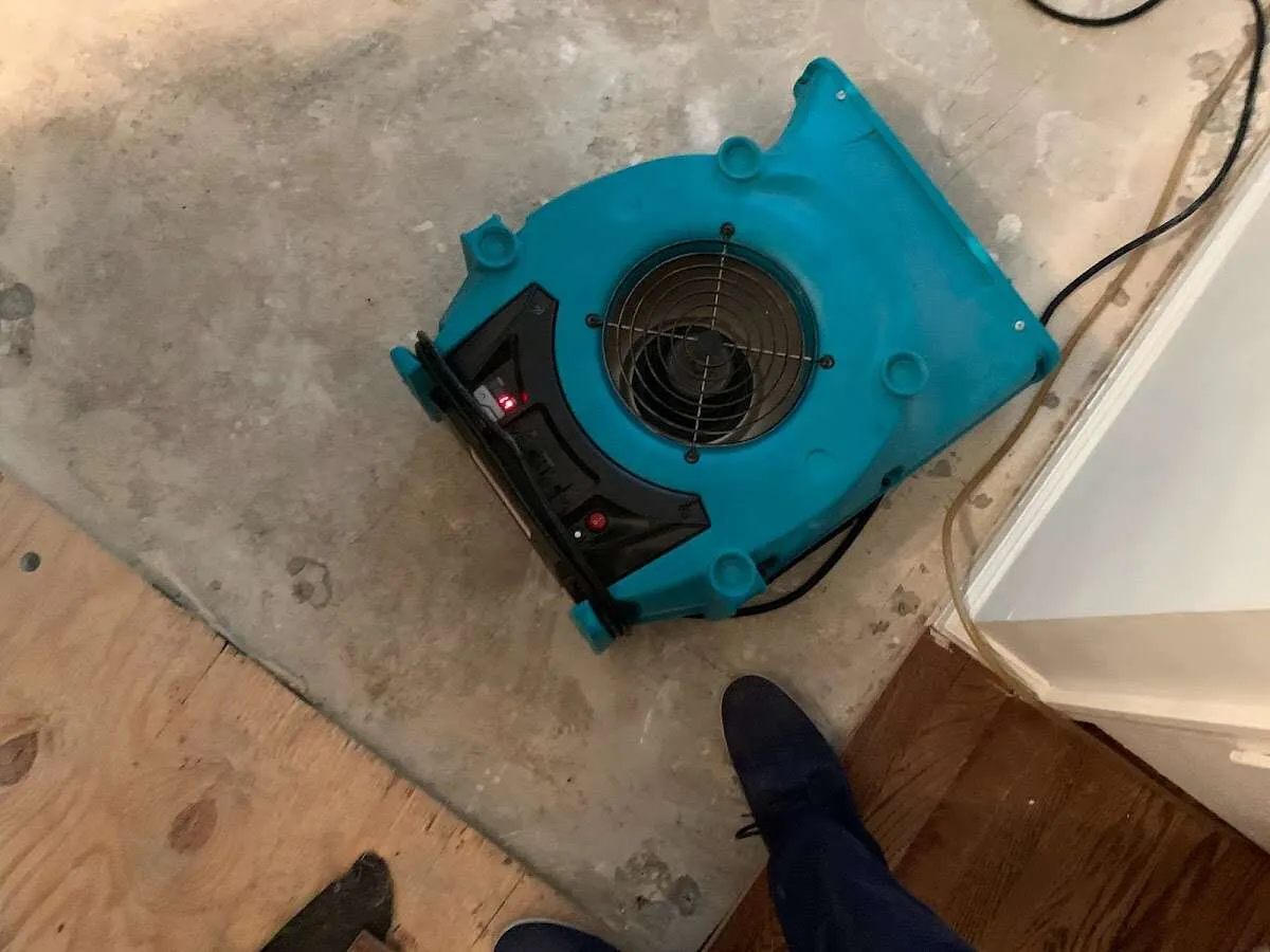 Air mover drying subfloor during Commercial Water Damage Restoration in Natchez
